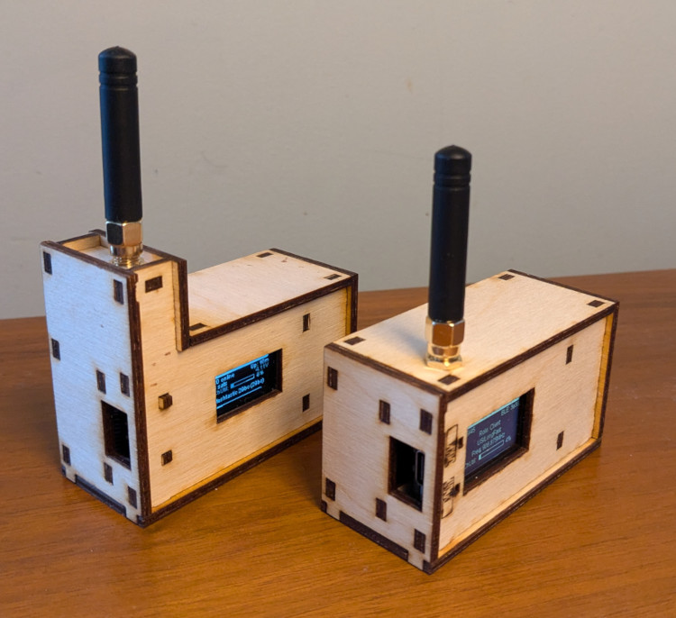 A photograph of a pair of Meshtastic radios housed in custom laser-cut wood enclosures